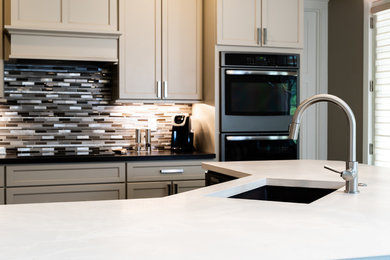 Large eat-in kitchen photo in Other with concrete countertops, an island and white countertops