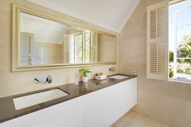 Photo of a mid-sized modern master bathroom in Perth with an undermount sink, beige cabinets, solid surface benchtops, an open shower, a two-piece toilet, beige tile, stone tile and beige walls.