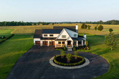 Example of a mid-sized minimalist white two-story concrete fiberboard and board and batten exterior home design in Philadelphia with a mixed material roof and a black roof