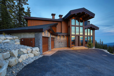 Mountain style multicolored three-story mixed siding and board and batten house exterior photo in Other