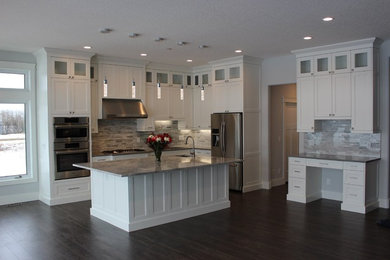 Inspiration for a large contemporary l-shaped brown floor open concept kitchen remodel in Edmonton with an undermount sink, shaker cabinets, white cabinets, quartzite countertops, gray backsplash, stainless steel appliances, an island and gray countertops