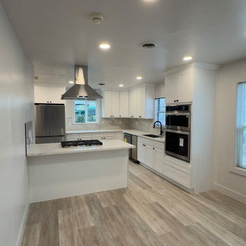 Contemporary White Kitchen with Peninsula Cooktop