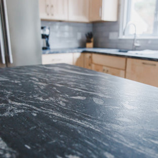 Photo of a mid-sized traditional galley kitchen pantry in Boston with a farmhouse sink, shaker cabinets, light wood cabinets, granite benchtops, grey splashback, ceramic splashback, stainless steel appliances, with island and green benchtop.