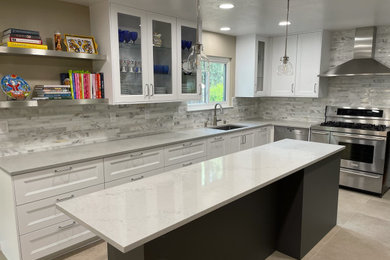 Inspiration for a transitional u-shaped porcelain tile and beige floor eat-in kitchen remodel in San Francisco with an undermount sink, shaker cabinets, white cabinets, quartz countertops, gray backsplash, mosaic tile backsplash, stainless steel appliances, an island and gray countertops