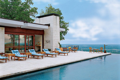 Pool house - mid-sized modern stone and custom-shaped infinity pool house idea in DC Metro