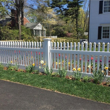 Cape Cod in Spring Time"ActiveYards Chestnut" vinyl fencing. The Chestnut model