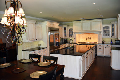 Elegant kitchen photo in New Orleans with an undermount sink and stainless steel appliances