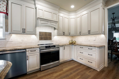 Inspiration for a mid-sized timeless u-shaped vinyl floor and brown floor kitchen pantry remodel in Philadelphia with an undermount sink, raised-panel cabinets, white cabinets, granite countertops, white backsplash, subway tile backsplash, stainless steel appliances, an island and brown countertops