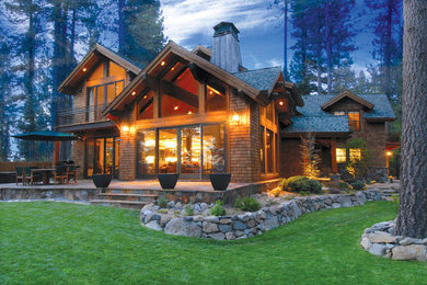 Large mountain style brown two-story wood exterior home photo in Other with a shingle roof