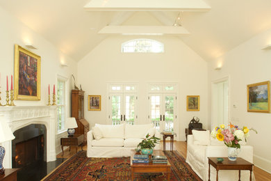 Example of a mid-sized classic formal and open concept living room design in New York with beige walls, a standard fireplace, a plaster fireplace and no tv