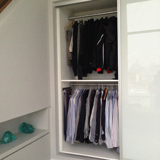 Example of a mid-sized minimalist gender-neutral reach-in closet design in New York