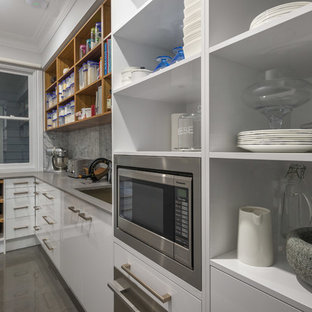 Traditional kitchen pantry inspiration - Inspiration for a timeless porcelain floor kitchen pantry remodel in Brisbane with an undermount sink, white cabinets, quartz countertops, gray backsplash, stone tile backsplash and stainless steel appliances