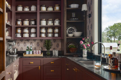 Inspiration for a country u-shaped beige floor and wallpaper ceiling kitchen pantry remodel in Dallas with an undermount sink, beaded inset cabinets, red cabinets, no island and black countertops