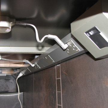 One puck light is installed in each of two undercabinet bays. Additional duplex