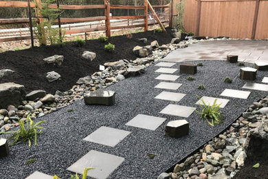Design ideas for a mid-sized asian backyard partial sun garden in Seattle with concrete pavers.
