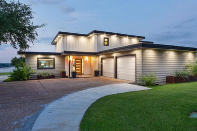 Inspiration for a large contemporary beige two-story vinyl and clapboard exterior home remodel in San Francisco with a mixed material roof