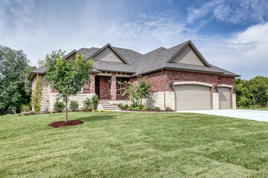 Inspiration for a transitional one-story concrete house exterior remodel in Wichita with a shingle roof