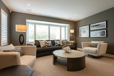 Living room library - large modern enclosed light wood floor and beige floor living room library idea in Auckland with a standard fireplace, a stone fireplace and a wall-mounted tv