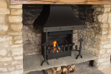 Inspiration for a large country formal enclosed living room in Other with a standard fireplace and a stone fireplace surround.