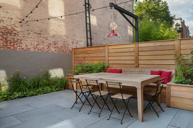 Patio - small contemporary backyard stone patio idea in New York
