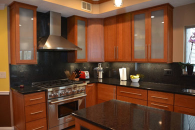 Eat-in kitchen - mid-sized transitional l-shaped eat-in kitchen idea in Other with recessed-panel cabinets, quartz countertops, black backsplash, stainless steel appliances, an island and medium tone wood cabinets