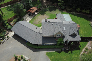 Photo of a large traditional two-storey beige house exterior in Seattle with a shingle roof.