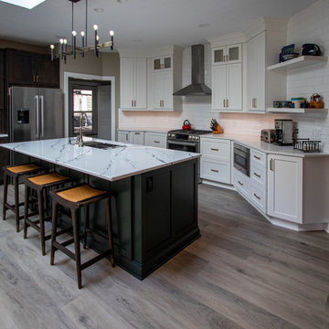 3 Finishes on Kitchen Cabinetry with Galley Workstation in Island and Wine Bar