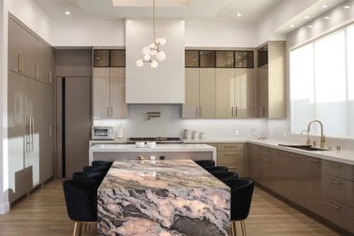 Large minimalist laminate floor kitchen photo in Los Angeles with an integrated sink, flat-panel cabinets, beige cabinets, quartzite countertops, white backsplash, paneled appliances and green countertops