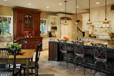 Inspiration for a mid-sized timeless galley ceramic tile and brown floor eat-in kitchen remodel in Philadelphia with a double-bowl sink, raised-panel cabinets, white cabinets, granite countertops, white backsplash, stone tile backsplash, paneled appliances and an island
