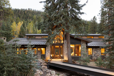 Example of a large mountain style one-story metal exterior home design in Denver with a metal roof and a black roof