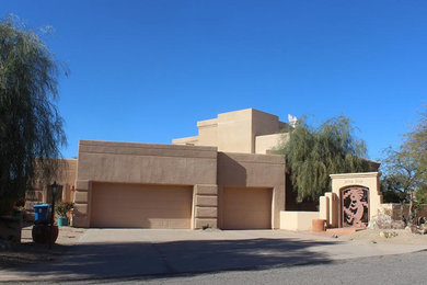 Large southwestern beige one-story adobe exterior home idea in Phoenix