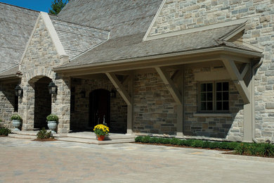 Example of a mountain style stone exterior home design in Toronto