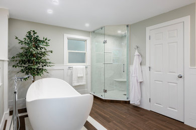 Inspiration for a large modern master ceramic tile, brown floor, double-sink and wainscoting bathroom remodel in Boston with gray walls, marble countertops, a hinged shower door, a niche and a built-in vanity