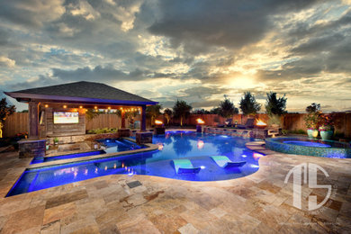 Large minimalist backyard tile and custom-shaped pool photo in Houston