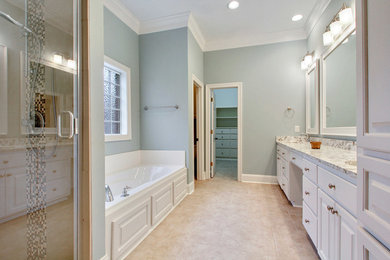 Bathroom - large transitional master beige tile and mosaic tile ceramic tile bathroom idea in Jackson with raised-panel cabinets, white cabinets, blue walls, an undermount sink and granite countertops