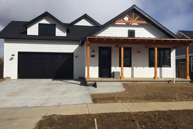 Inspiration for a cottage white one-story exterior home remodel in Other with a shingle roof
