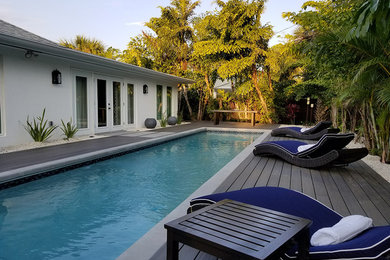 This is an example of a mid-sized tropical home design in Miami.