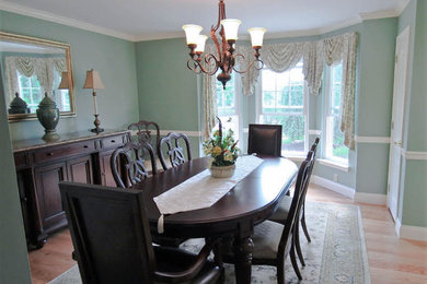 Mid-sized traditional separate dining room in Philadelphia with green walls, light hardwood floors and brown floor.