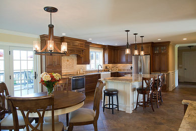 Eat-in kitchen - large traditional l-shaped porcelain tile eat-in kitchen idea in Boston with a farmhouse sink, dark wood cabinets, granite countertops, beige backsplash, porcelain backsplash, stainless steel appliances and an island