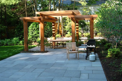 Mid-sized asian backyard patio in New York with natural stone pavers.