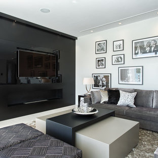 This is an example of a contemporary home cinema in Other with black walls and a built-in media unit.