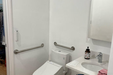 Mid-sized trendy powder room photo with a bidet, an undermount sink, quartzite countertops and white countertops