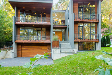 Large minimalist gray three-story mixed siding exterior home photo in DC Metro with a metal roof