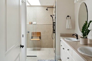 Bathroom - mid-sized traditional master beige tile and porcelain tile porcelain tile, beige floor and double-sink bathroom idea in Portland with beige walls, a hinged shower door and a built-in vanity