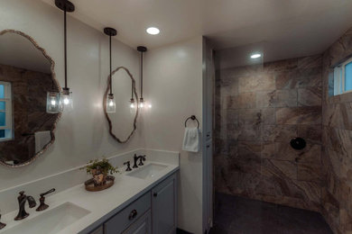 Photo of a modern bathroom in Los Angeles with a shower/bath combination, a one-piece toilet, white tiles, porcelain tiles, blue walls, porcelain flooring, a submerged sink, grey floors, a hinged door and white worktops.