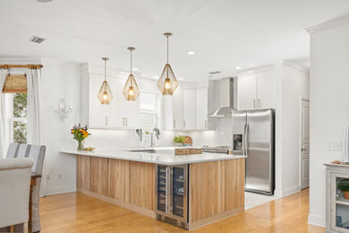 Small beach style u-shaped kitchen photo in Other with a farmhouse sink, quartz countertops and stone slab backsplash