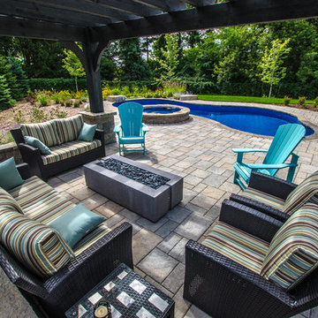 Custom curved pool with spillover hot tub - Georgetown