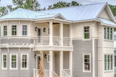 Transitional two-storey grey exterior in Wilmington with wood siding.