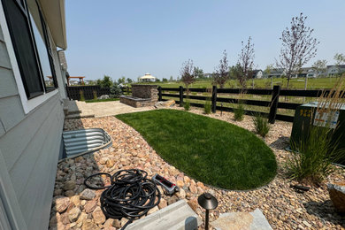 Design ideas for a mid-sized traditional drought-tolerant and full sun backyard brick landscaping in Denver with a fireplace for summer.
