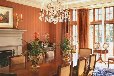 Example of a mid-sized classic enclosed dining room design in New York with brown walls, a standard fireplace and a stone fireplace